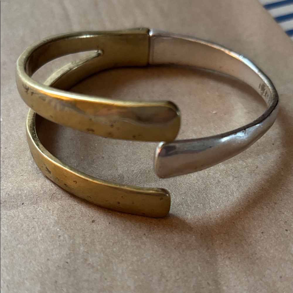Lucky Brand two-tone hinged bracelet.
